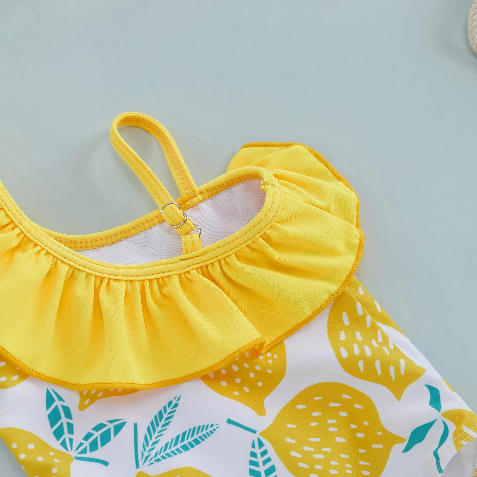 Baby Girl's one-shoulder lemon print swimsuit by Baby Bubble, featuring bright, cheerful summer swimwear for infants.
