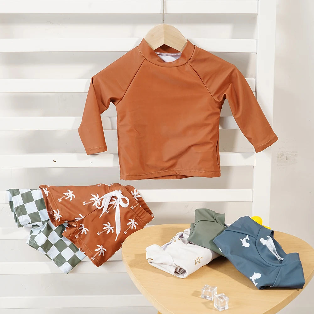 Baby boys' 2-piece swimsuit by Baby Bubble featuring a colorful cool print set, with sleeveless top and matching swim trunks.