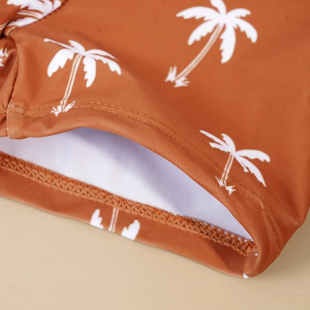 Baby Boy's 2-piece swimsuit set by Baby Bubble featuring a colorful cool print, includes a swim top and shorts for beach or pool.