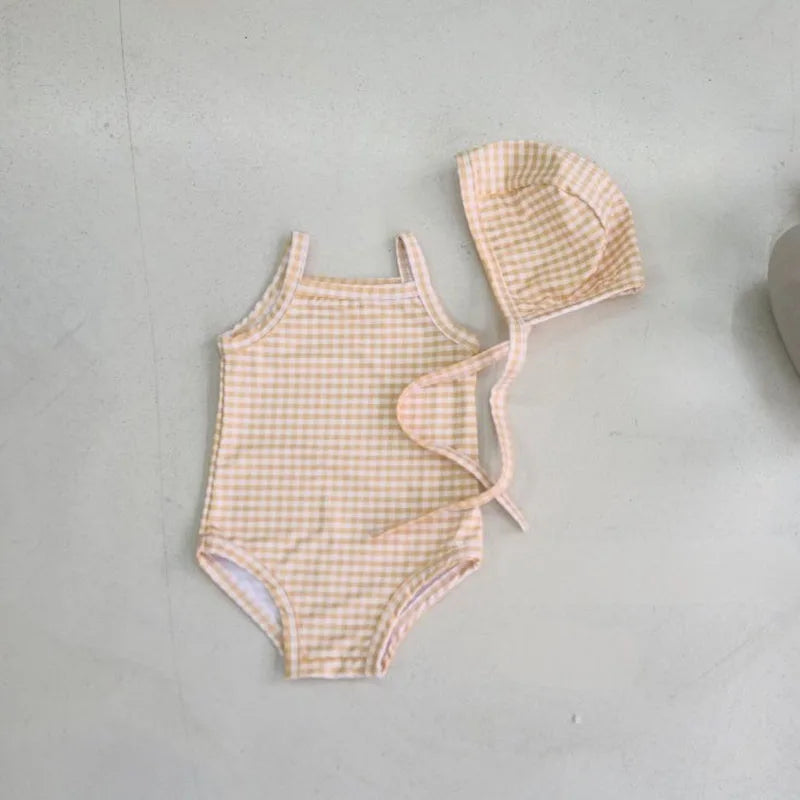 Baby girl swimwear set with one-piece suit and sun hat from Baby Bubble, featuring colorful patterns and a comfortable fit.