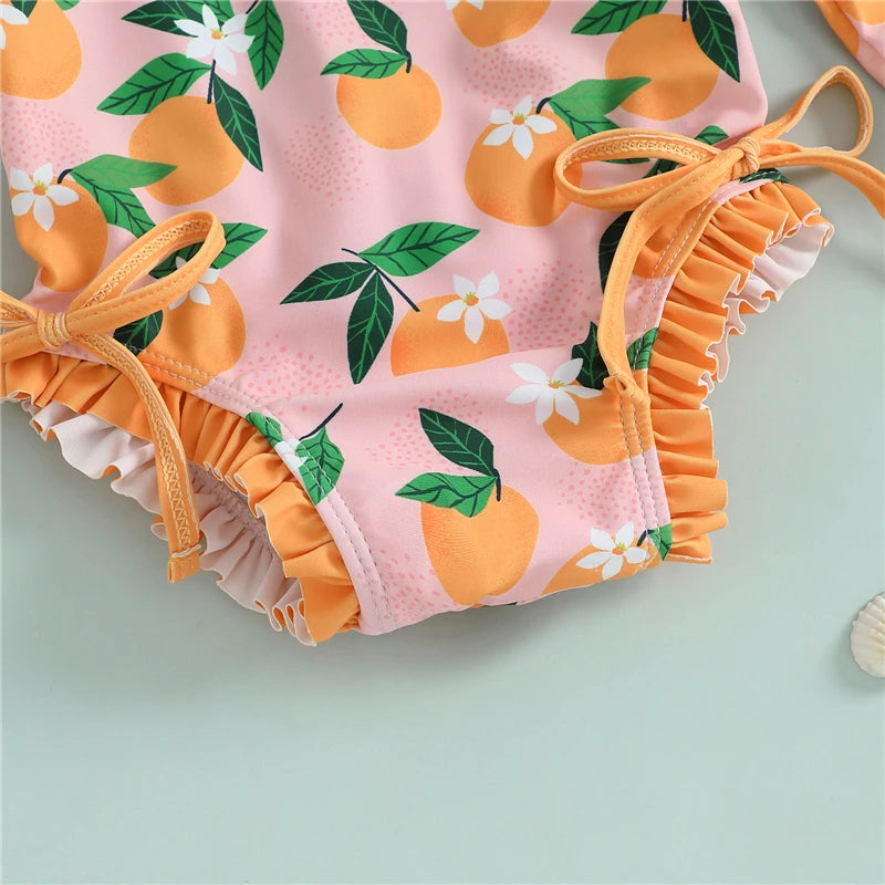 Baby girl wearing a Baby Bubble rash guard swimsuit and matching swim cap, suitable for sun protection and swimming.