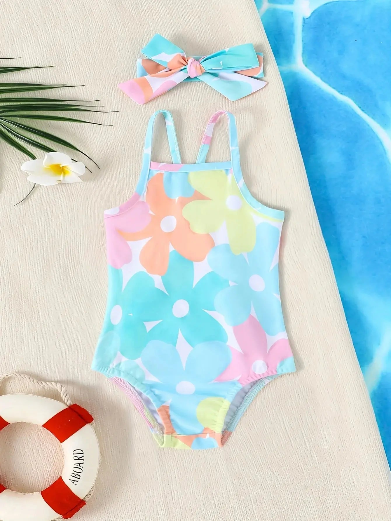 Baby Girl one-piece swimsuit by Baby Bubble, suitable for newborns and toddlers, featuring colorful floral pattern and adjustable straps.
