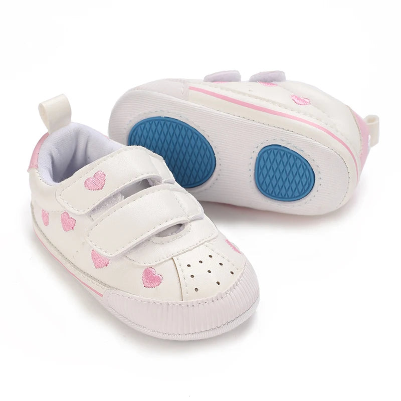 Baby girl soft sole crib shoes in pink with bow detail, designed for first walkers, by Baby Bubble.