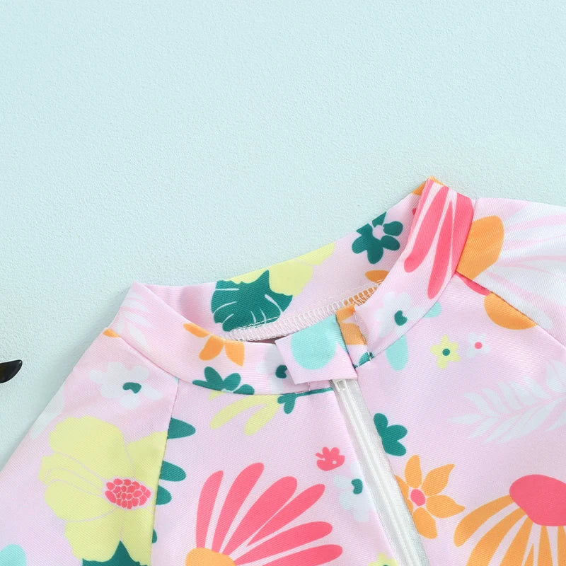 Baby girls floral zip-up rash guard romper by Baby Bubble, featuring colorful flower patterns and short sleeves.