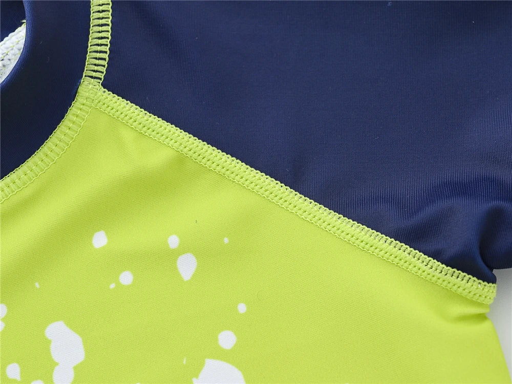 Boy wearing Baby Bubble boys 2-piece swimsuit set with cool print, suitable for ages 1 to 7, featuring vibrant colors and fun design.