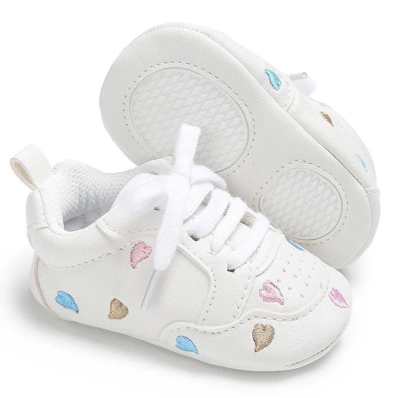 Baby Girl soft sole crib shoes by Baby Bubble, first walker style with pink and white details, designed for newborns and infants.