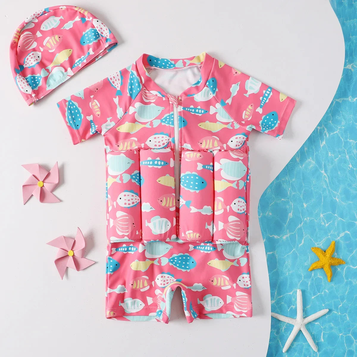 Children's buoyancy swimsuit with colorful cartoon print by Baby Bubble, featuring adjustable straps and safety foam for swimming.