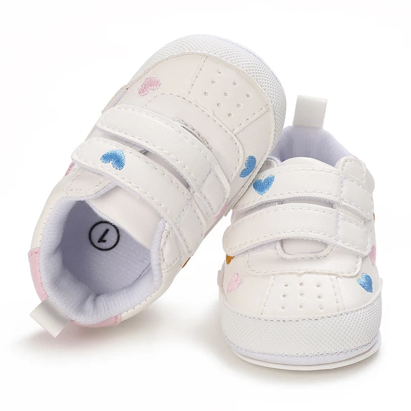 Baby girl soft sole crib shoes in pink with bow detail, designed for first walkers, by Baby Bubble.