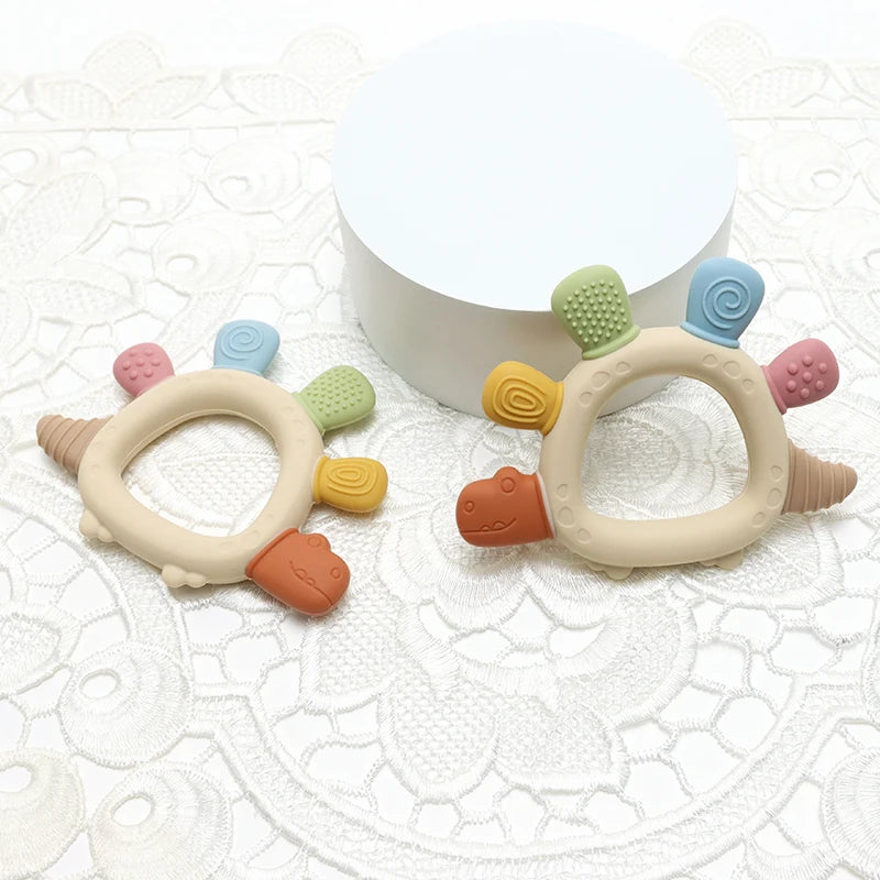 Baby Bubble BPA-free baby dinosaur teether with easy-grip handle, designed for gum relief and teething comfort.