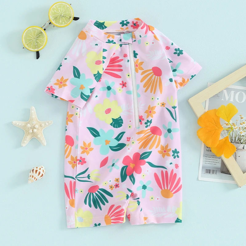 Baby Girls floral zip-up rash guard romper by Baby Bubble, with colorful floral pattern and comfortable neckline, suitable for sun protection.
