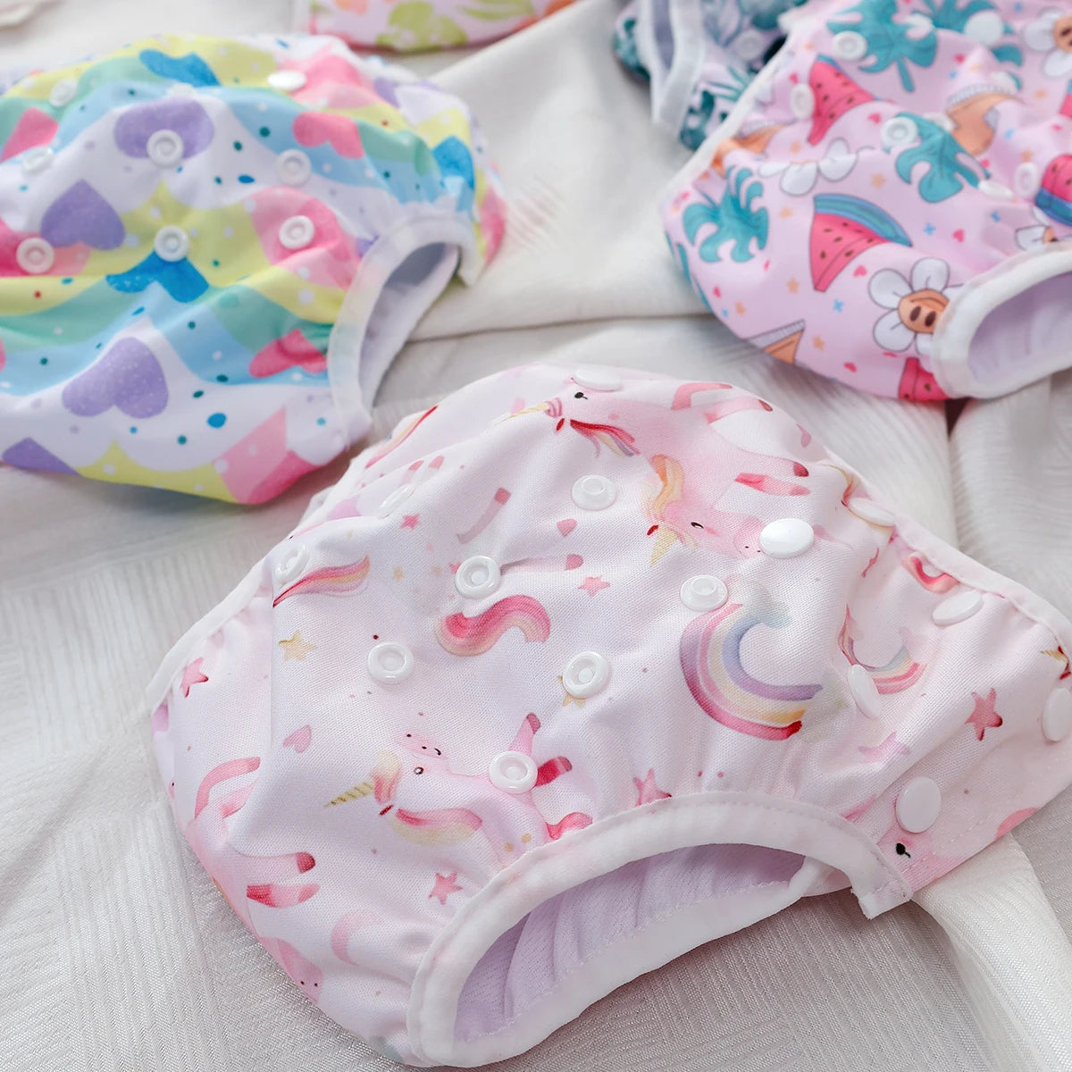 Baby Bubble washable and adjustable baby swim diapers shown in a close-up image with colorful patterns and snug fit.