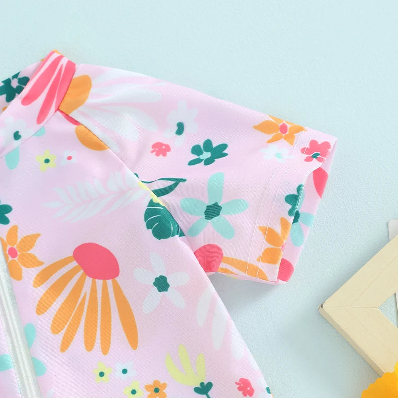 Baby Girl's floral zip-up rash guard romper by Baby Bubble, featuring colorful flower patterns and comfortable fit for sun protection.
