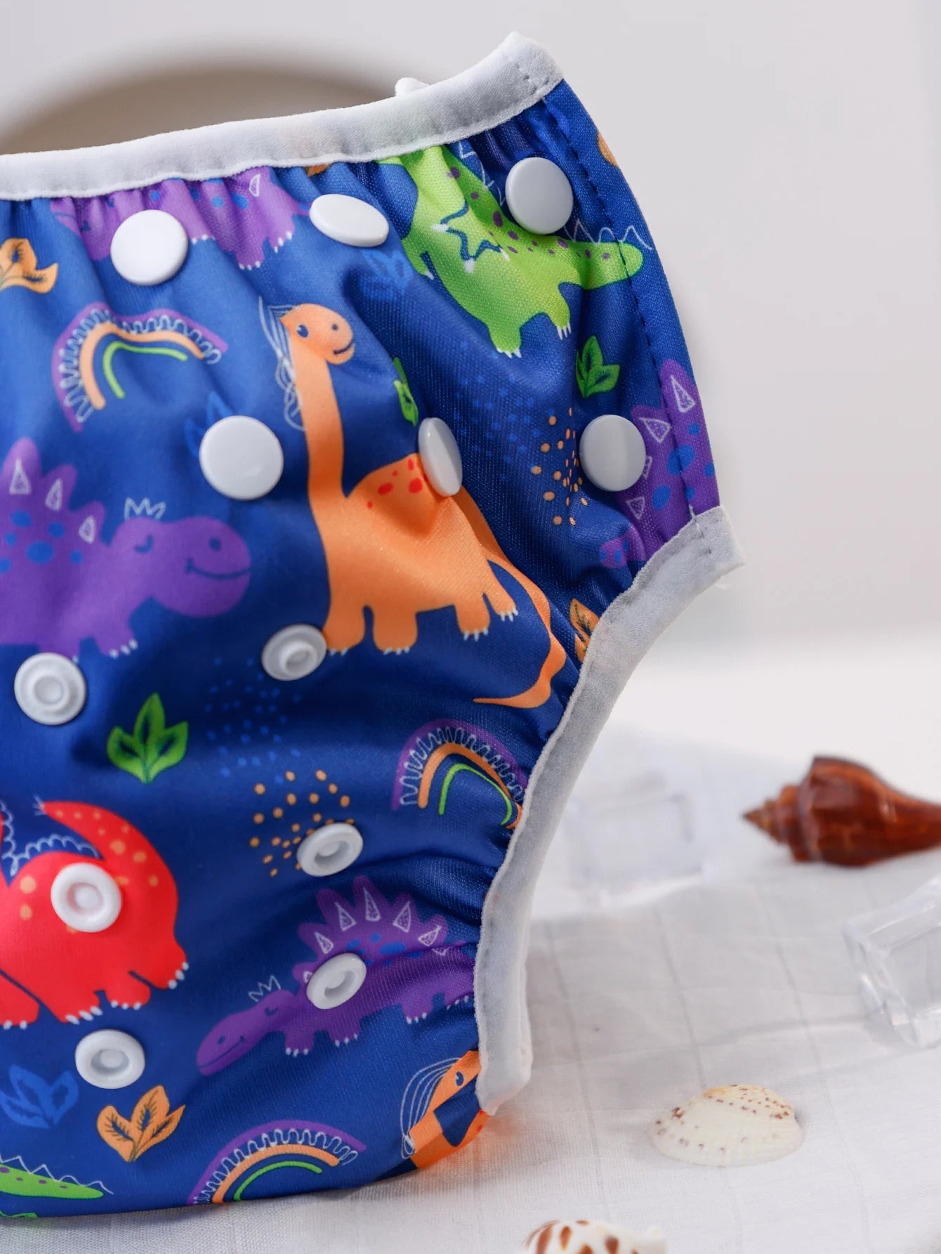 Baby Bubble reusable swim diapers with colorful animal print design, suitable for infants and toddlers during pool time.