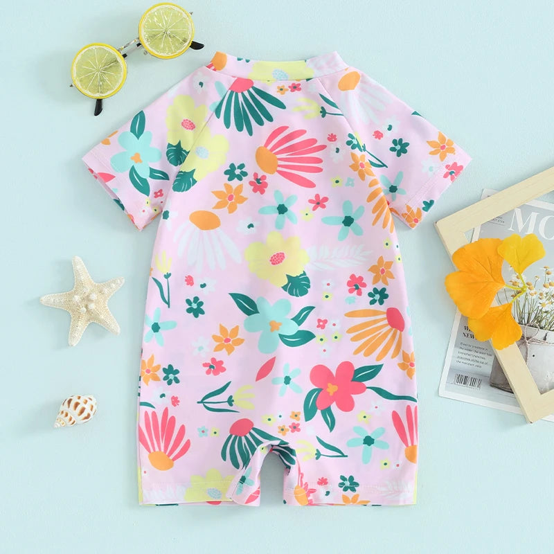 Baby girls floral zip-up rash guard romper by Baby Bubble, featuring bright floral pattern and front zipper for easy dressing.