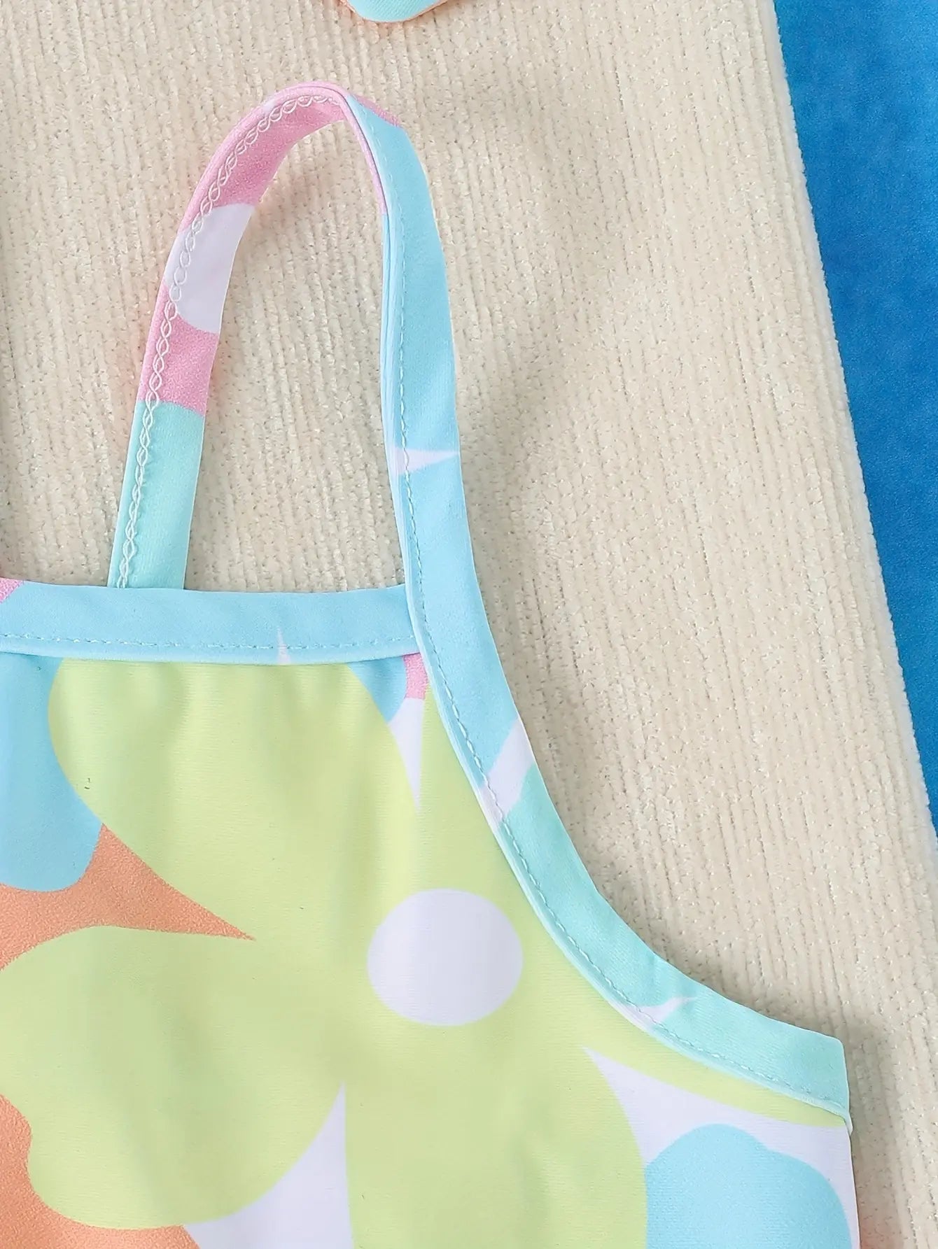 Baby Girl one-piece swimsuit by Baby Bubble, featuring colorful patterns, suitable for newborns and toddlers.