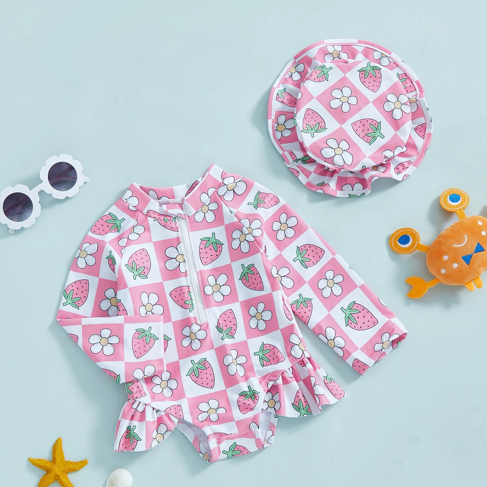 Baby girl wearing floral rash guard with hat from Baby Bubble, zip-up swimsuit, showing colorful floral pattern and sun protection hat.