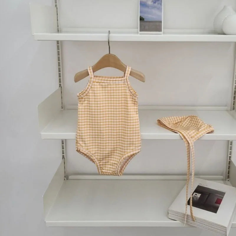 Baby girl swimwear set with one-piece swimsuit and sun hat, featuring colorful patterns and soft fabric for summer beach fun.