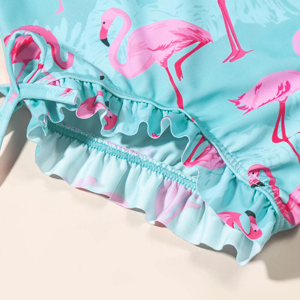 Girls flamingo-themed long sleeve UV one-piece swimsuit by Baby Bubble, featuring a colorful flamingo pattern on soft fabric.