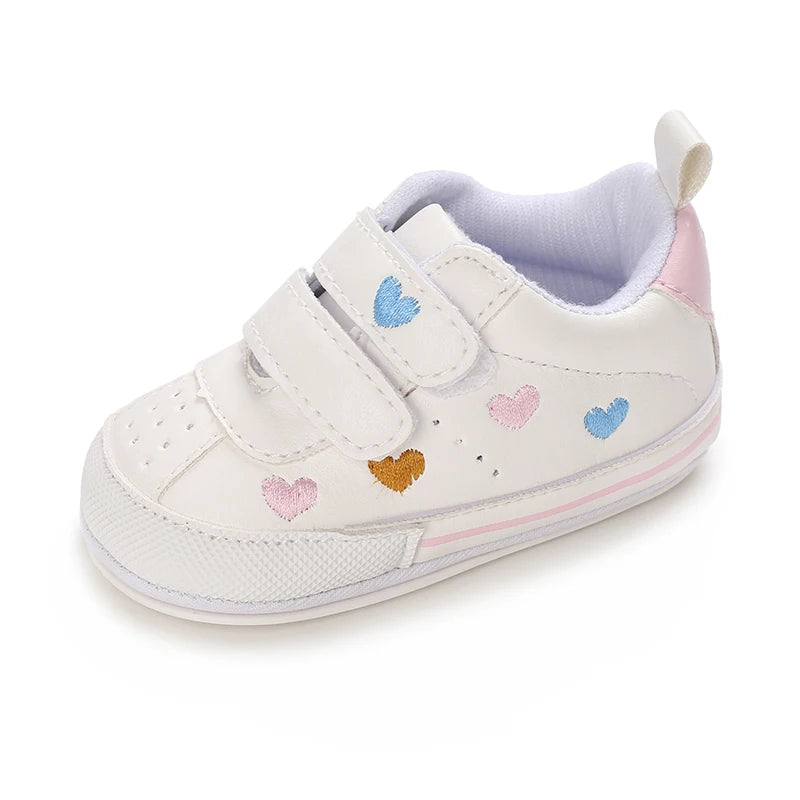 Baby girl soft sole crib shoes by Baby Bubble, first walker style, with pink and white design and adorable bow details.