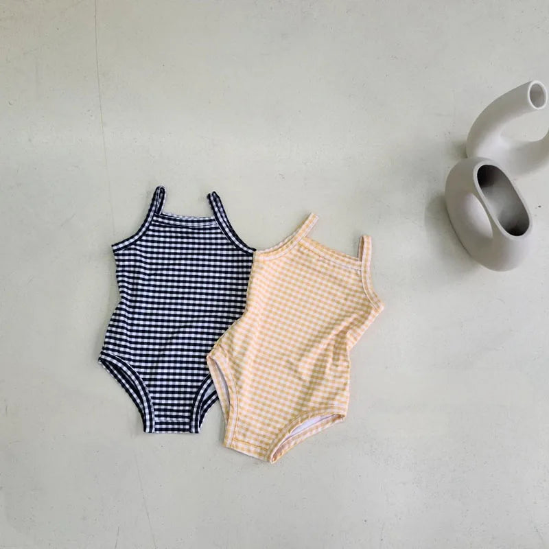 Baby Bubble baby girl swimwear set with one-piece swimsuit and sun hat, featuring colorful patterns and lightweight fabric.