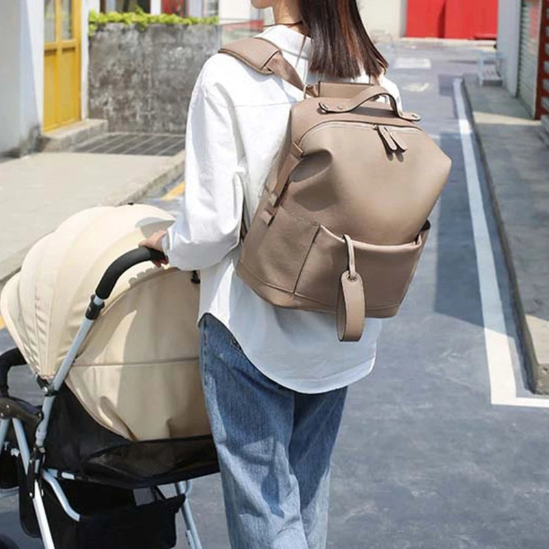Large leather diaper bag backpack by Baby Bubble, stylish and spacious for carrying baby essentials comfortably.
