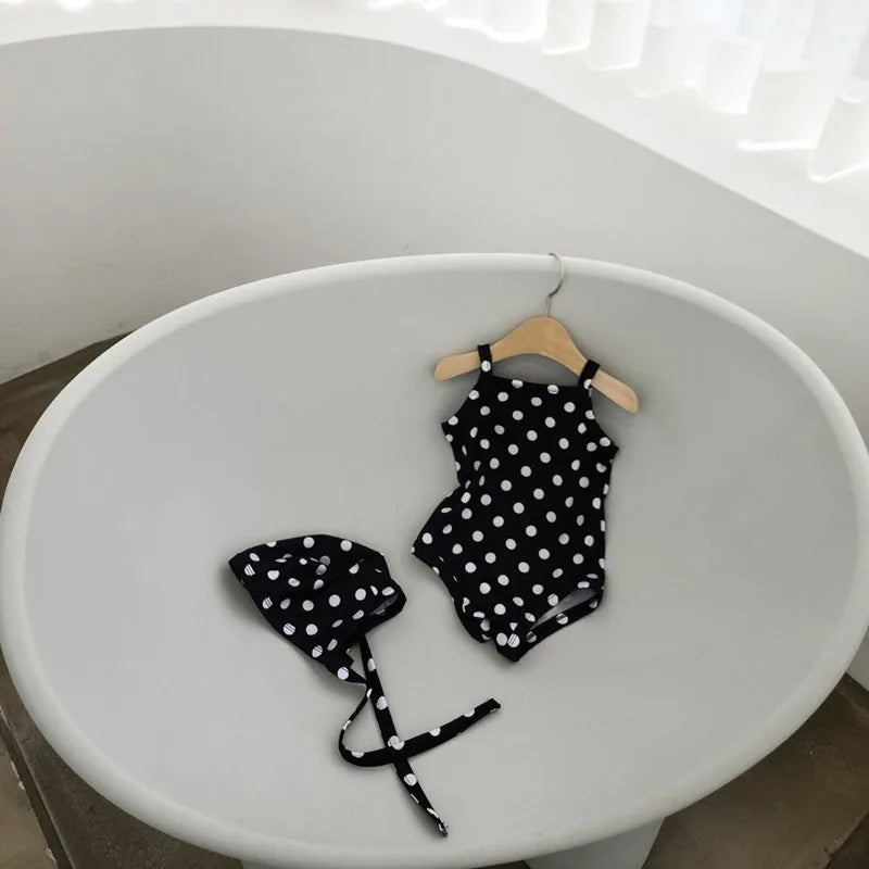 Baby Girl swimwear set with one-piece swimsuit and sun hat, by Baby Bubble, featuring colorful design and sun protection accessories.