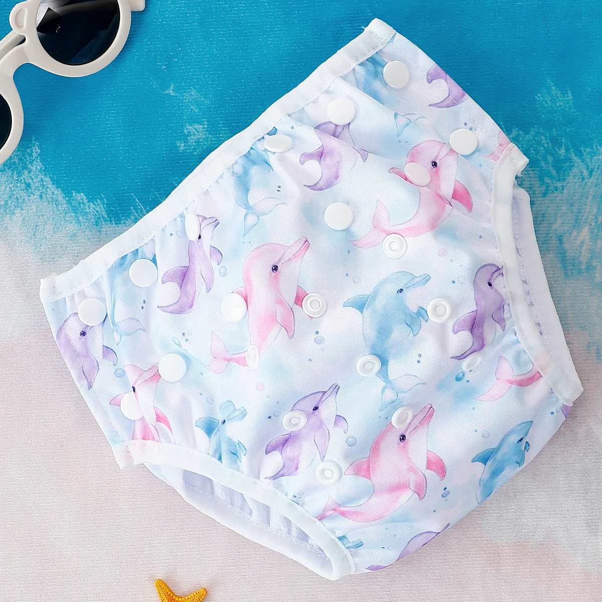 Baby Bubble reusable swim diapers with colorful animal print designs, perfect for infants during pool or beach fun.