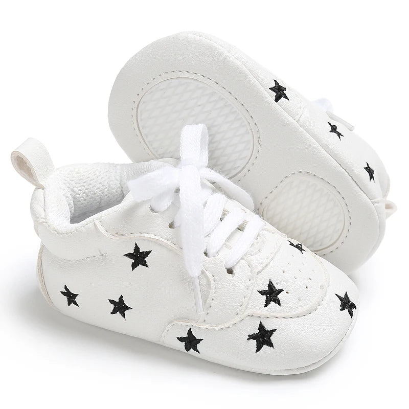 Baby girl soft sole crib shoes from Baby Bubble, designed as first walker footwear, with pink and white accents and soft leather soles.