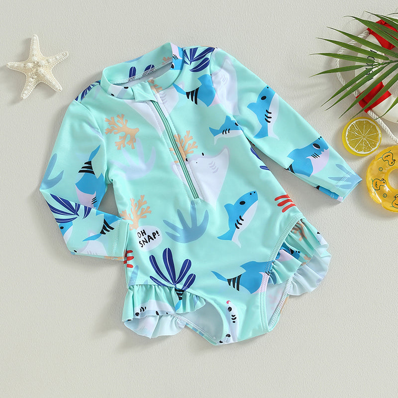Girl wearing a Baby Bubble long sleeve swimsuit with colorful sea animal print, suitable for swimming or beach outings.
