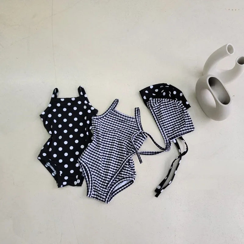 Baby Girl swimwear set with one-piece swimsuit and sun hat from Baby Bubble, featuring colorful patterns and soft fabric.
