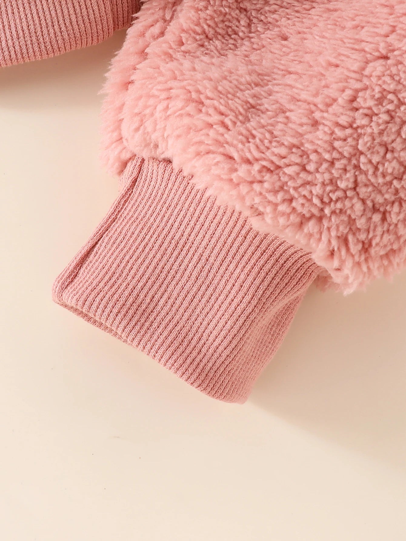 Baby girl in a fuzzy heart 3-piece outfit by Baby Bubble, featuring a cozy top, leggings, and a matching hat.