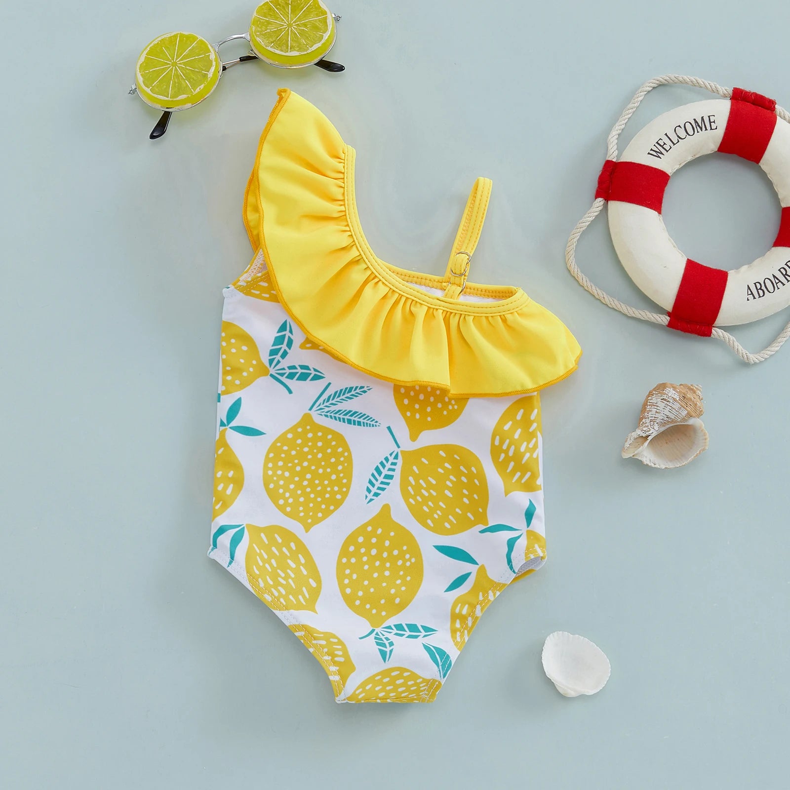 Baby girls one-shoulder swimsuit with lemon print by Baby Bubble, featuring a cute and colorful summer swimwear design.