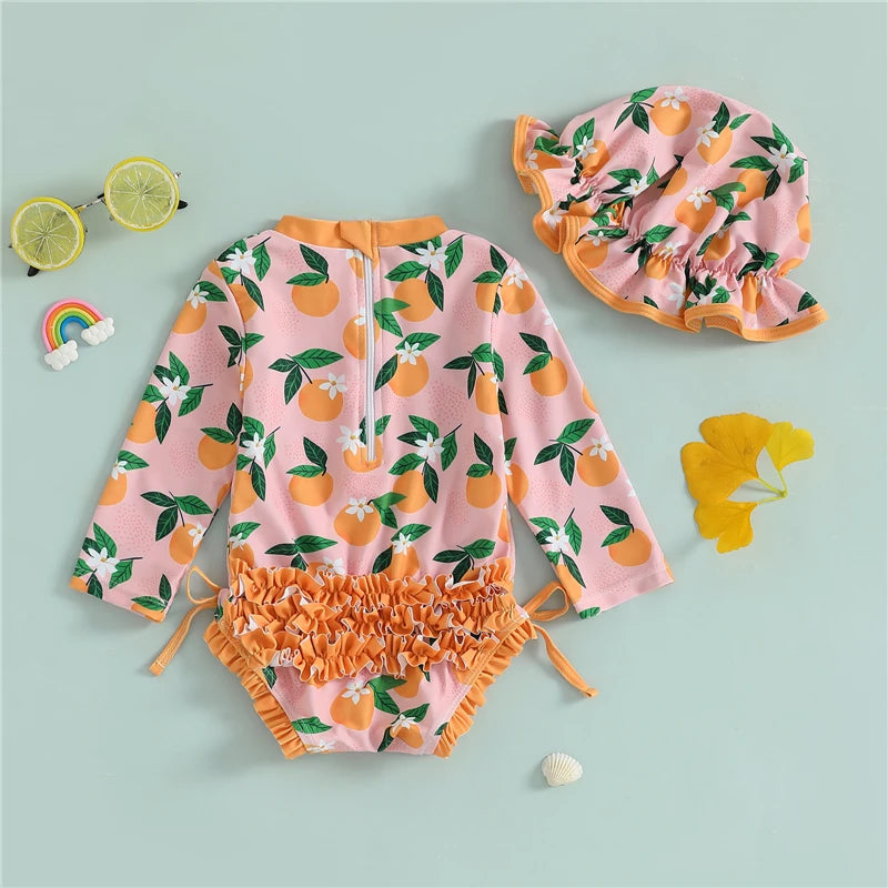 Baby girl wearing a Baby Bubble rash guard swimsuit and matching swim cap, suitable for sun protection and swimming.