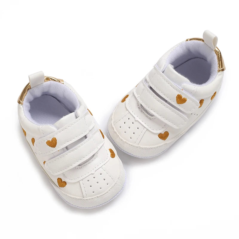 Baby girl soft sole crib shoes by Baby Bubble, first walker style with pink and white design, suitable for newborns and infants.