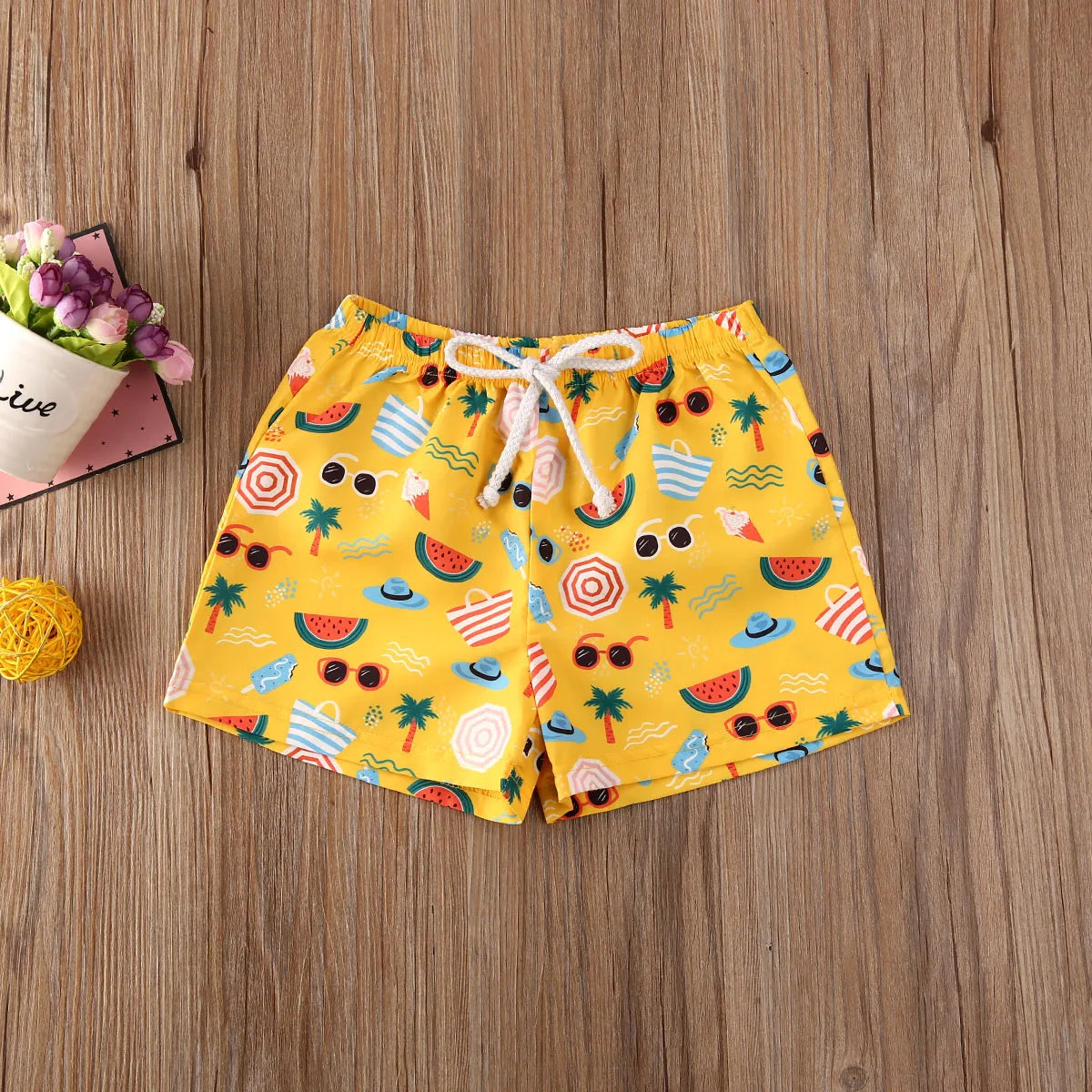 Kids swim shorts by Baby Bubble featuring quick-dry fabric and UV protection, shown in vibrant colors for outdoor water activities.