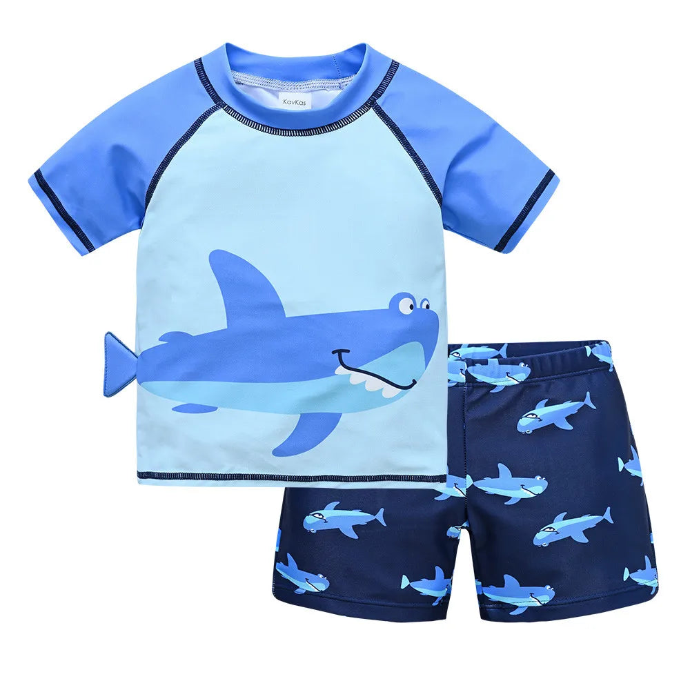 Boy wearing a Baby Bubble two-piece swimsuit set with a colorful cool print for ages 1 to 7, standing on the beach.