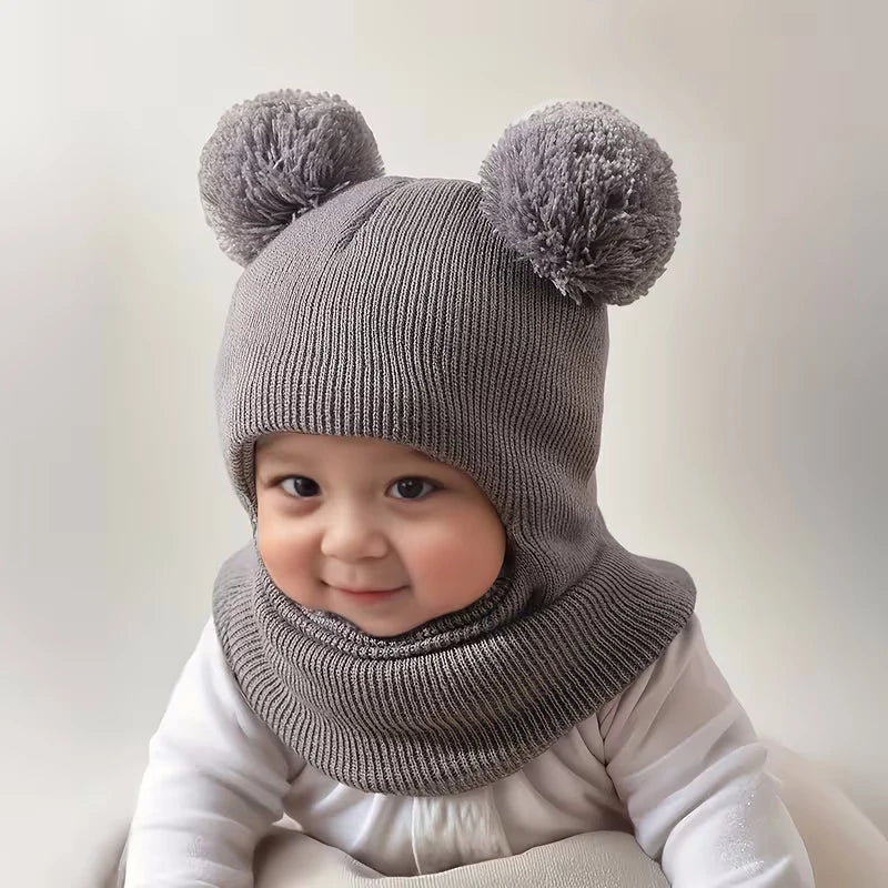 Baby Bubble winter children's hooded knitted cap, cozy and warm for kids, shown in soft winter colors.