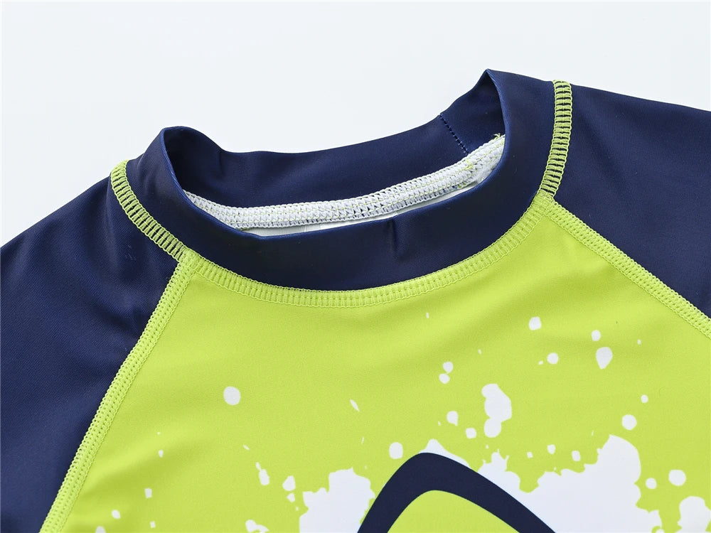 Boy wearing a Baby Bubble boys 2-piece swimsuit set with a colorful cool print, suitable for ages 1 to 7 years.