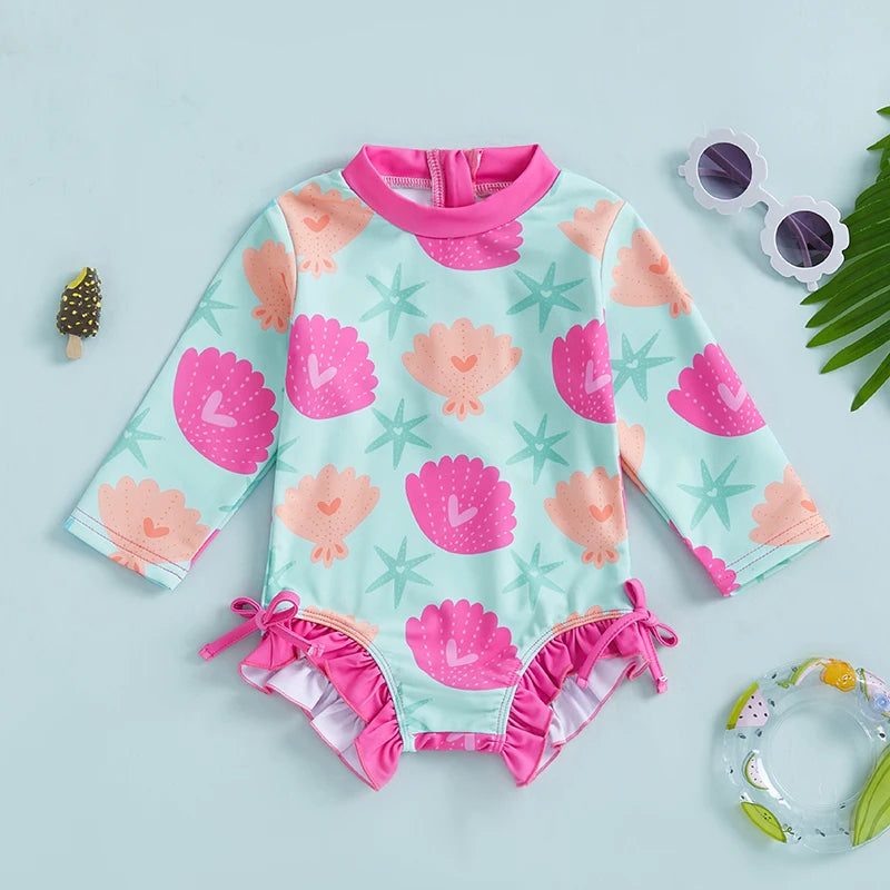 Baby girls' rash guard swimsuit with shell print from Baby Bubble, featuring UV protection and comfortable coverage for swimming.