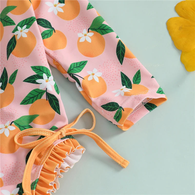 Baby girl wearing pink rash guard swimsuit with matching swim cap, designed for sun protection and comfort during swimming.