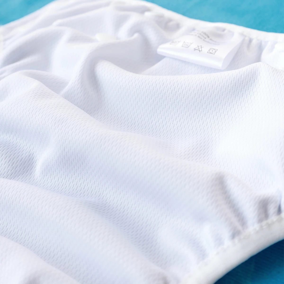 Baby Bubble washable baby swim diapers with adjustable fit, shown in a close-up of the reusable swim diaper on a baby.