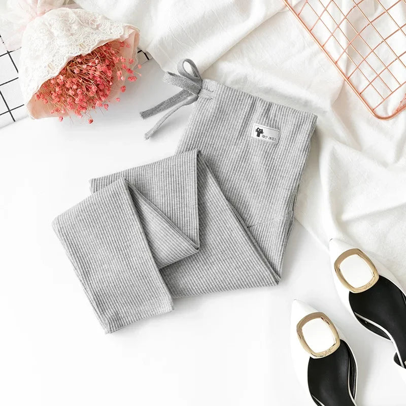 Pregnant woman wearing Baby Bubble adjustable maternity pants with soft high waist and comfortable fit in a cozy indoor setting.