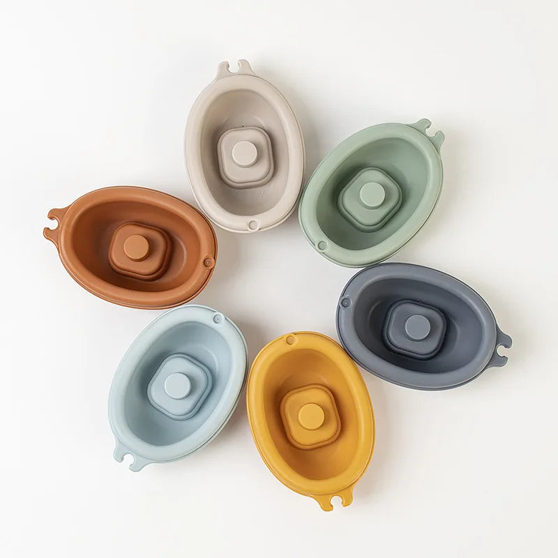 Colorful stacking boat toys from Baby Bubble, designed for kids' water play in the bath, featuring fun boat shapes and vibrant colors.