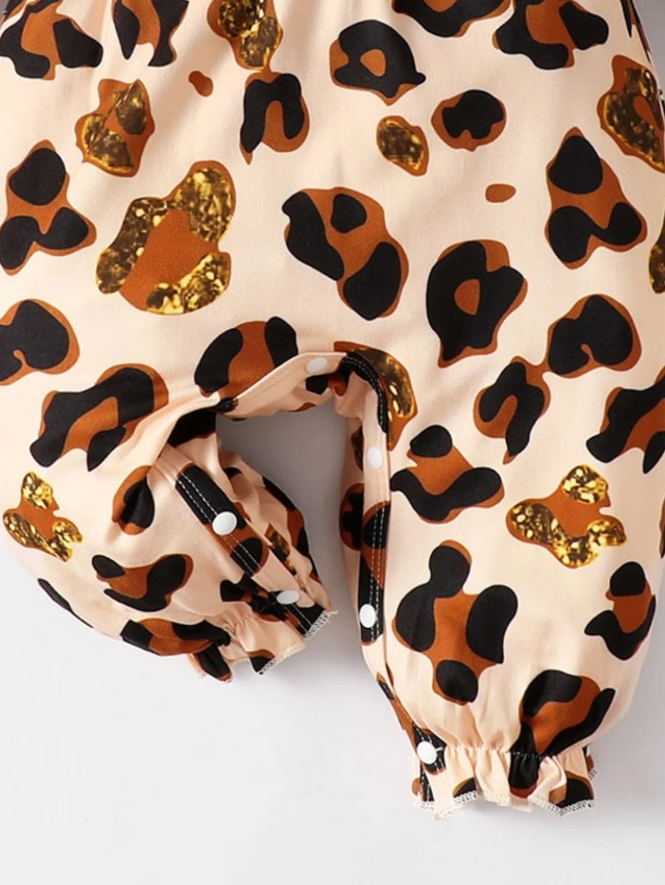 Baby Girl Leopard Jumpsuit Set by Baby Bubble featuring ruffle trim and matching headband, displayed on a soft background.