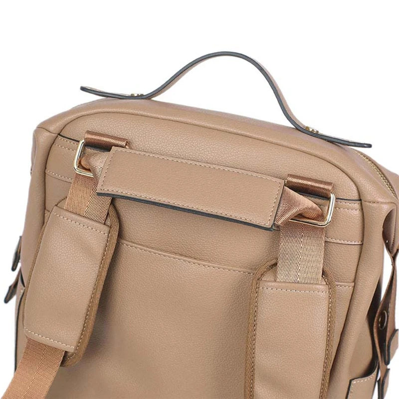 Large leather diaper bag backpack by Baby Bubble with multiple compartments and sturdy handles for parents on the go.