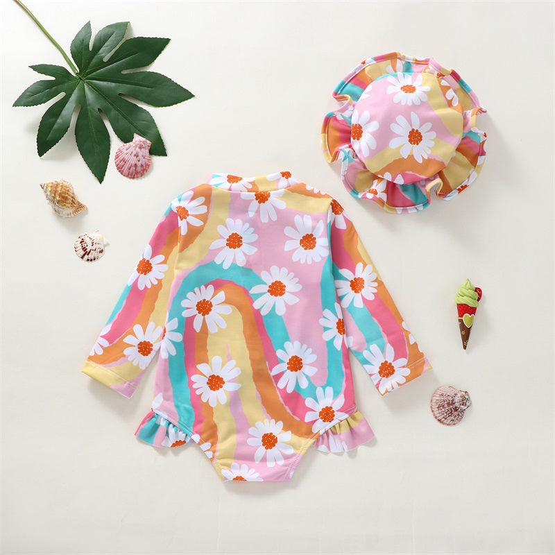 Baby Girl UV swimsuit with hat by Baby Bubble featuring long sleeves and zipper, shown on a baby girl ready for swimming.