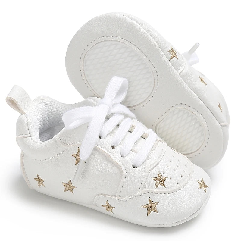 Baby girl soft sole crib shoes by Baby Bubble, first walker shoes with cute pink and white design for infants.