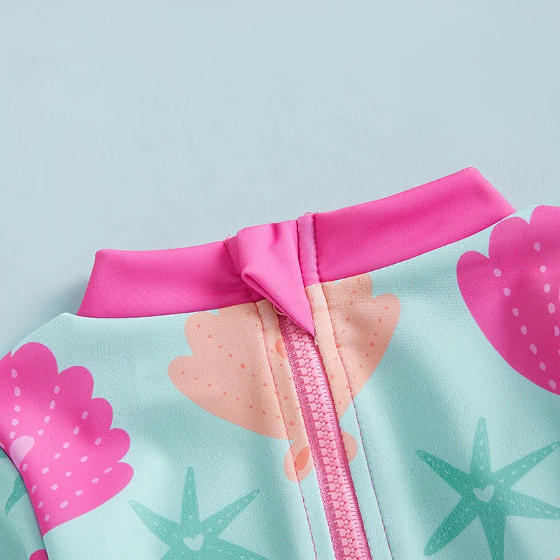 Baby girls' rash guard swimsuit with shell print from Baby Bubble, featuring UV protection for swimming and beach activities.