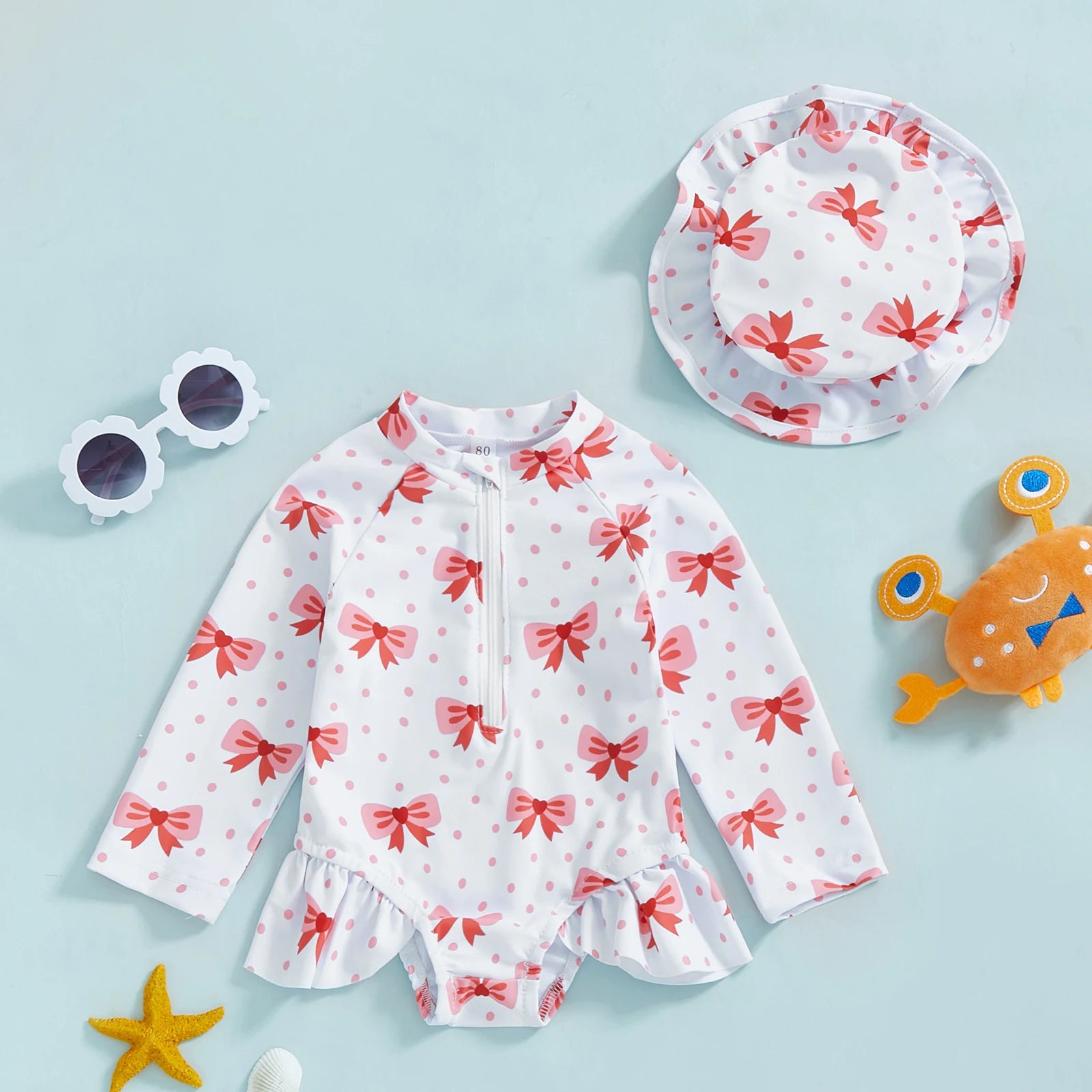 Baby girls floral rash guard with hat from Baby Bubble, featuring a zip-up design and sunny floral pattern for sun protection.