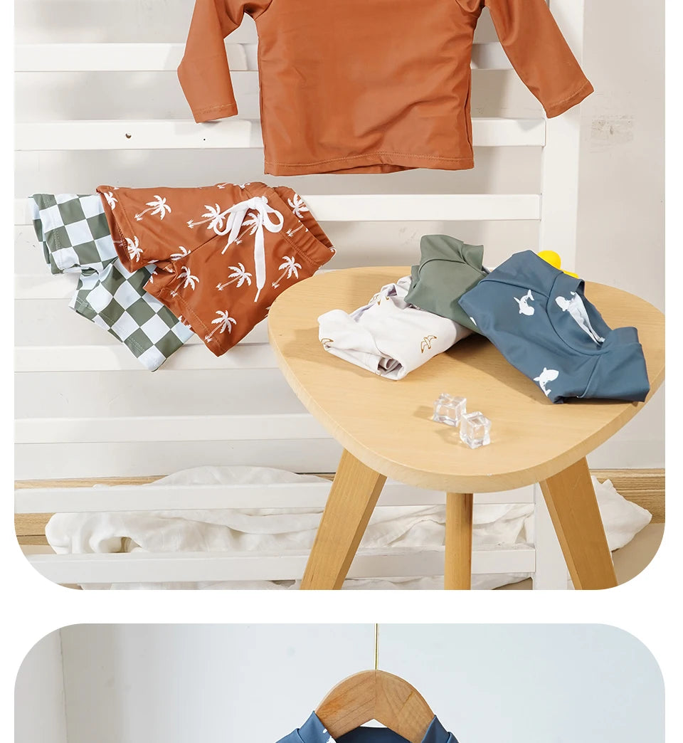 Baby boys 2-piece swimsuit set with cool print from Baby Bubble, featuring a colorful swim shirt and matching swim trunks.